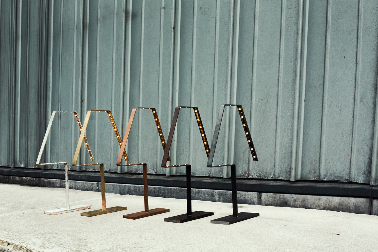 A photograph of Silhouet Lighting Lamps in a row in front of Arcam Architects by Poppyonto