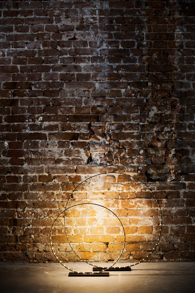 A photograph of Silhouet Lighting Circle in front of a brick wall at Trust Amsterdam by Poppyonto